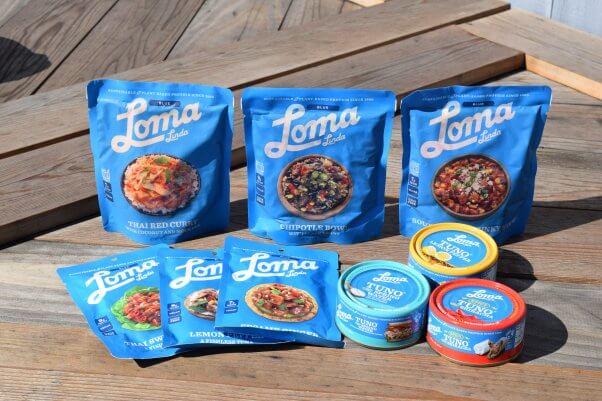 blue packages of vegan loma linda meals on wood