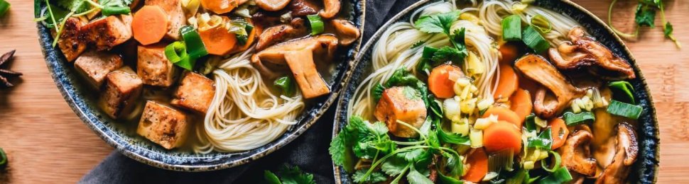 Vegan noodle bowl with tofu, mushrooms, onion, carrot