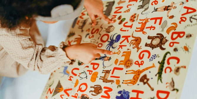 Child learning alphabet with animal pictures