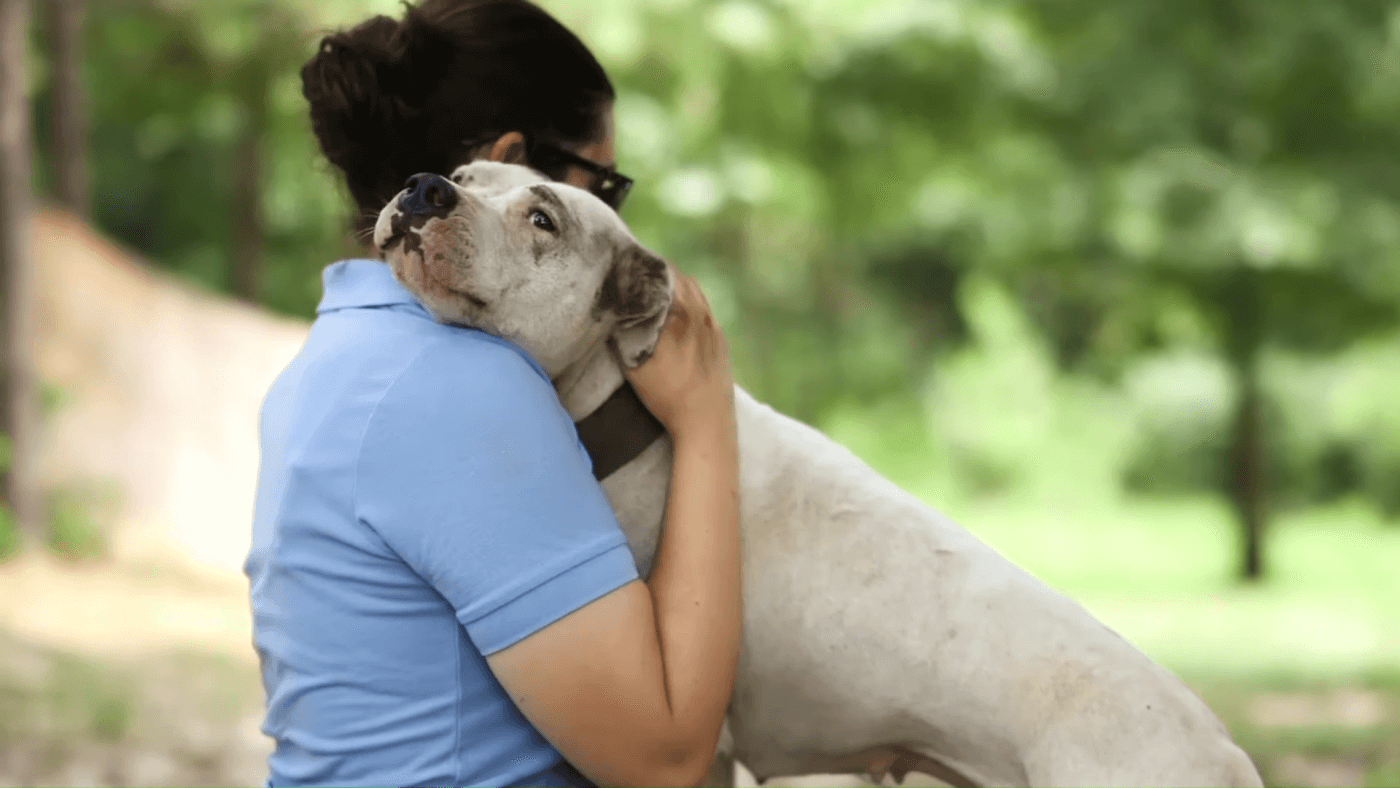PETA fieldworker showing dog some love