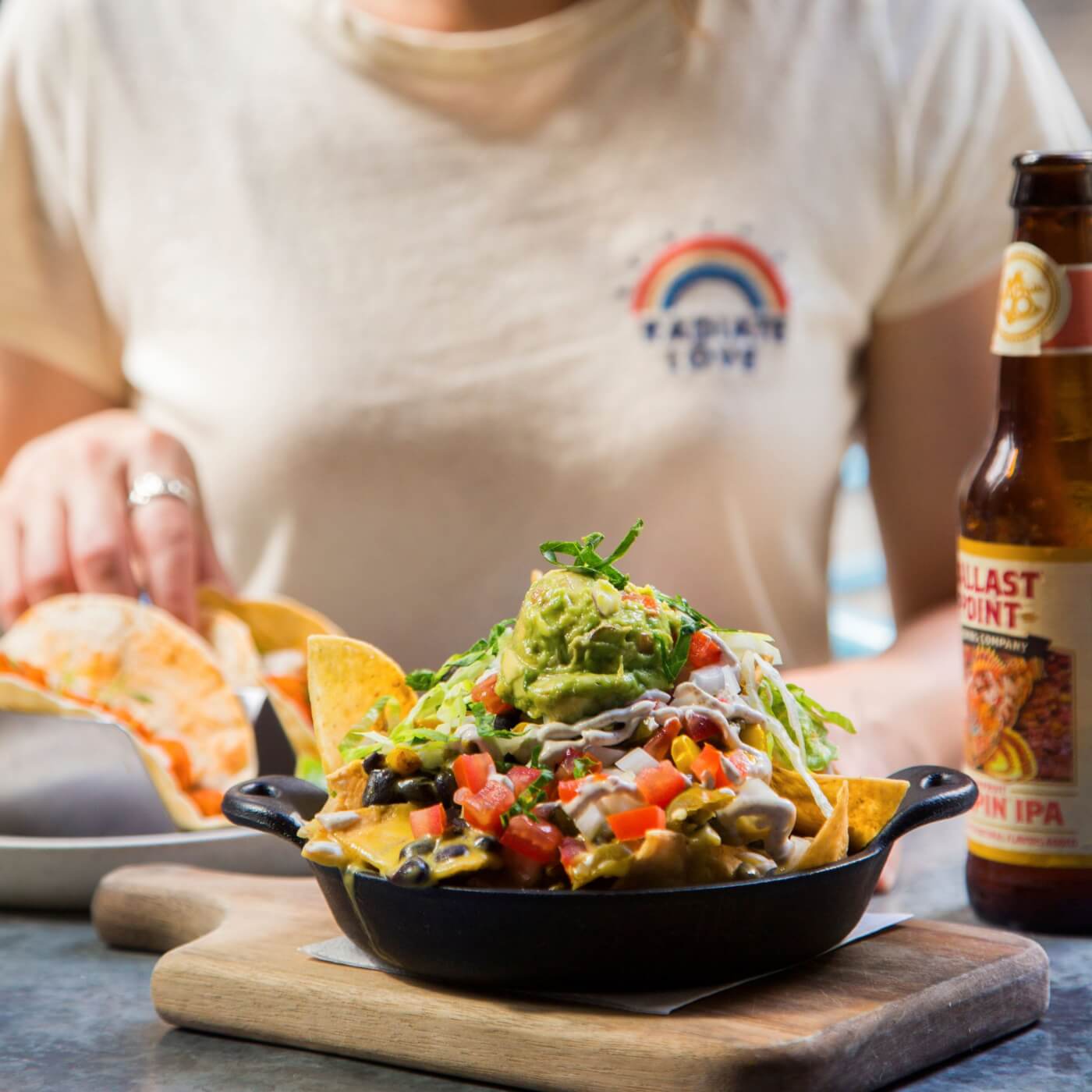 person in white shirt eating nachos