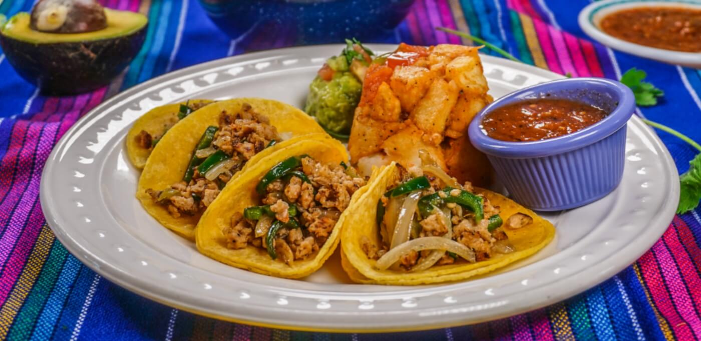 tacos on a plate with sauce