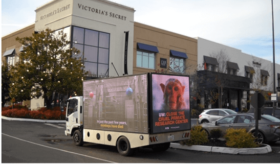 A mobile billboard calling for the closure of the cruel primate research center at UW