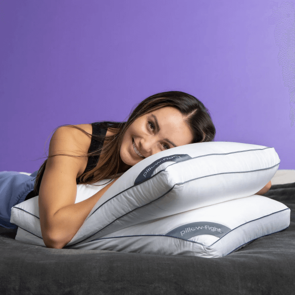 woman laying on a stack of two pillow-fight down-free pillows