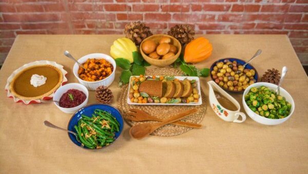 ThanksVegan spread of food with brick background