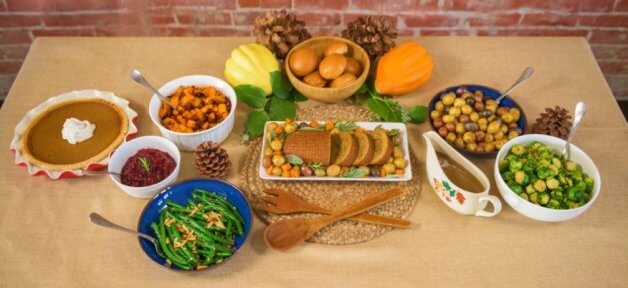 ThanksVegan spread of food with brick background