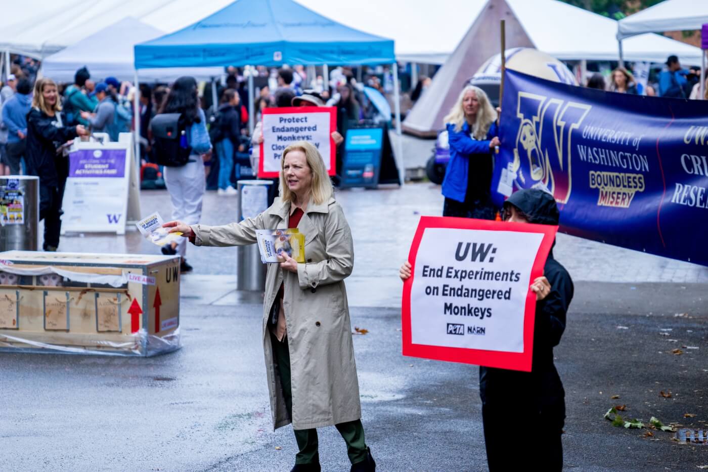 PETA protests the WANPRC on campus with signs and a banner