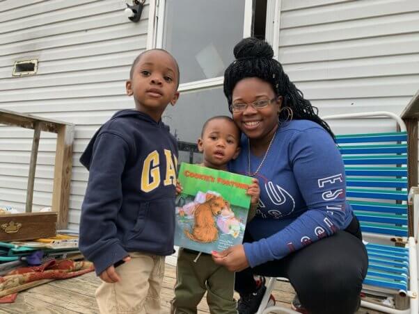 Kids Holding Books from PETA's Barks to Books Program