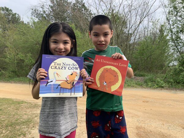 Kids Holding Books from PETA's Barks to Books Program