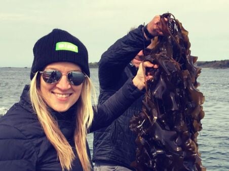 Beth Zotter holding red seaweed