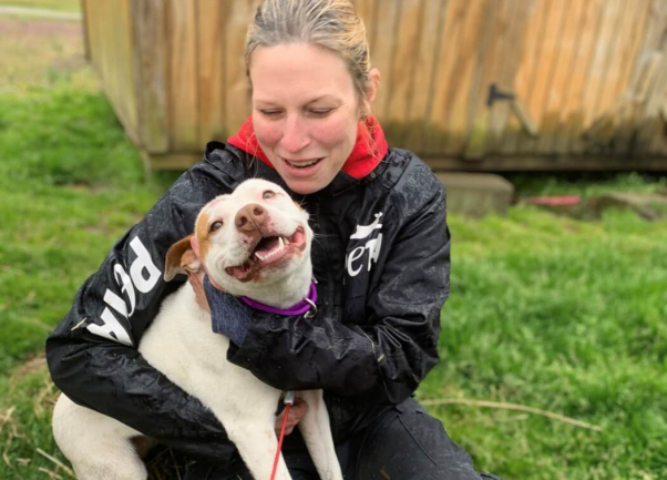 PETA Fieldworker and Princess the dog smiling