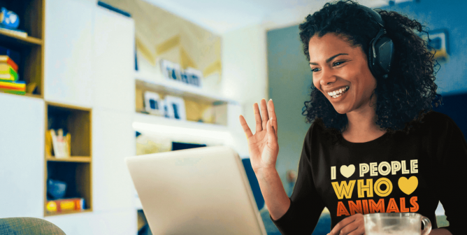 Person with PETA shirt working on computer