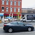 a truck with a mobile billboard that says "UMass Murderers"