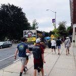 a truck with a mobile billboard that says "UMass Murderers"