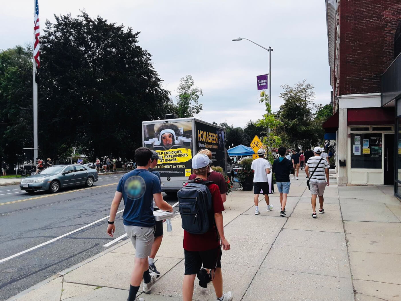 a truck with a mobile billboard that says "UMass Murderers"