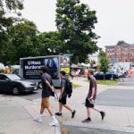 a truck with a mobile billboard that says "UMass Murderers"