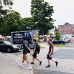 a truck with a mobile billboard that says "UMass Murderers"