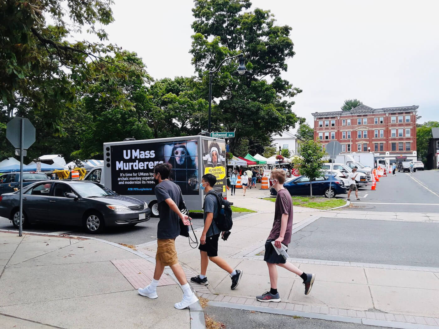 a truck with a mobile billboard that says "UMass Murderers"