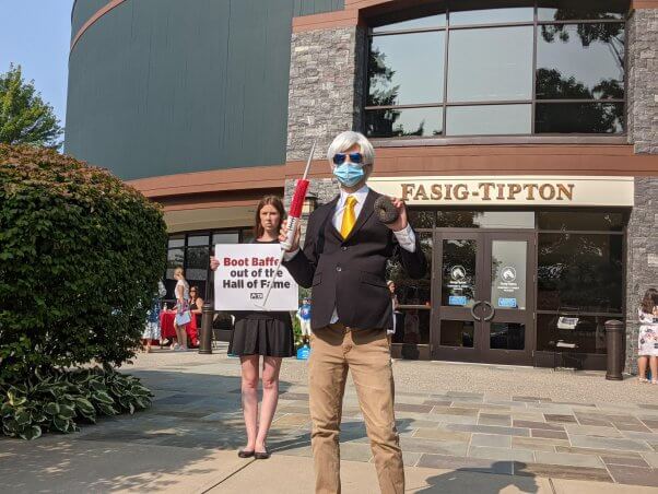 peta impersonates trainer Bob Baffert holding a poppy seed bagel