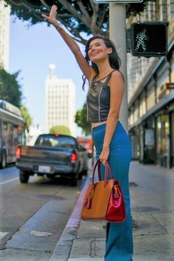 Person waving hand wearing vegan clothes