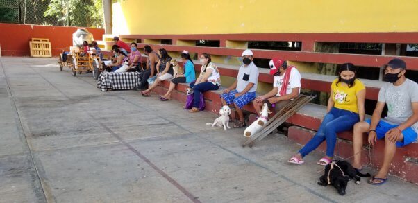 A line of guardians wait their turn at the PETA clinic