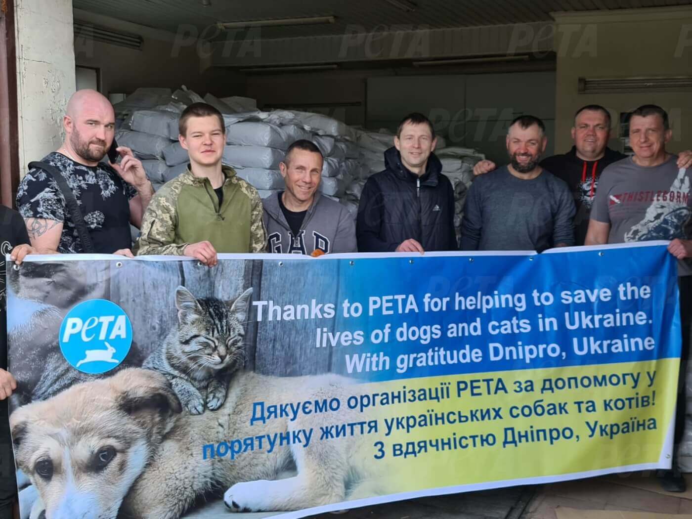Group of people holding a PETA banner
