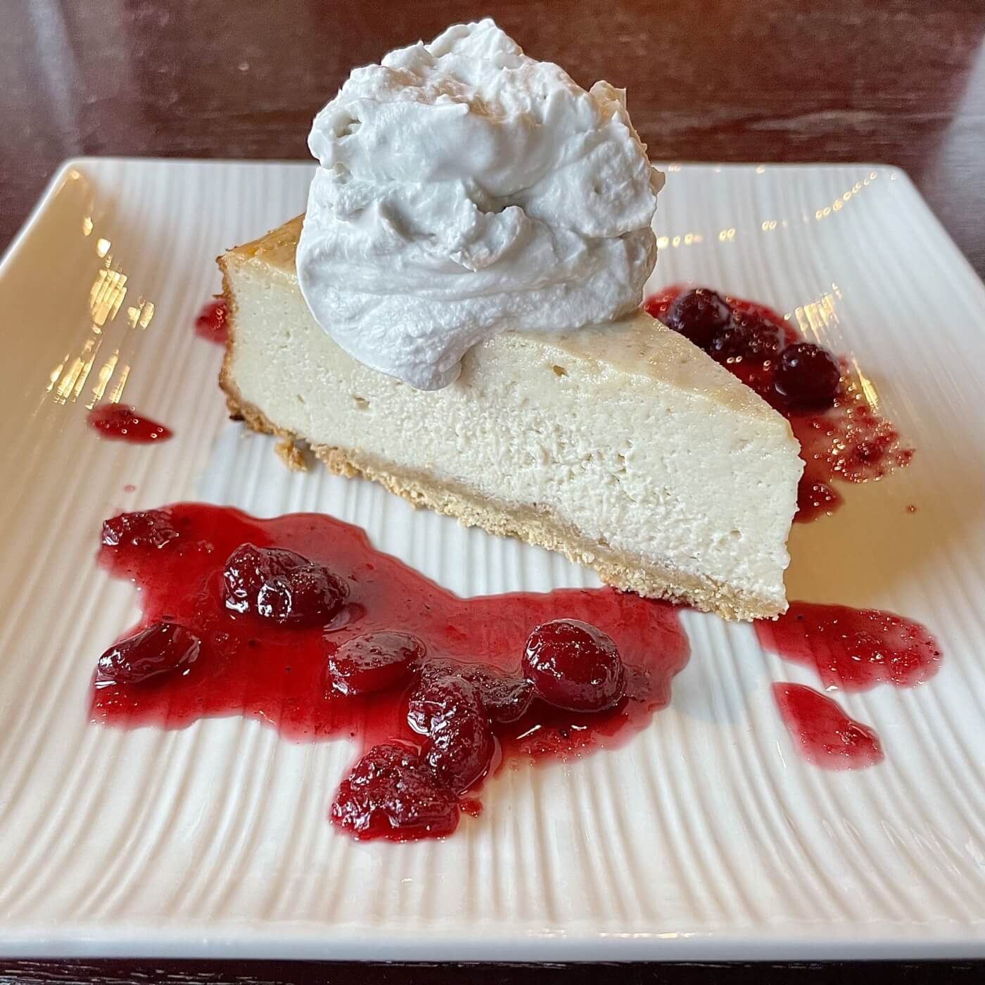 sprig and vine meyer lemon vegan cheesecake with berries and whipped cream