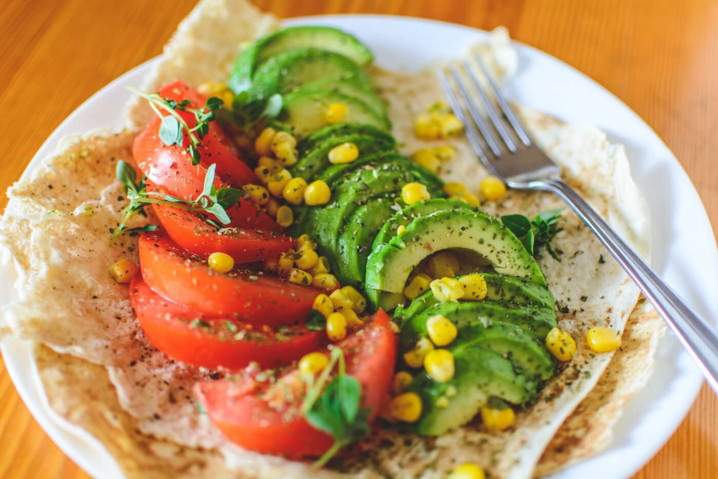 veggies in tortilla with tomato and avocado