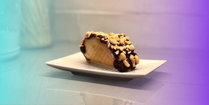 Vegan choco taco on a small white plate with teal and purple gradient background.