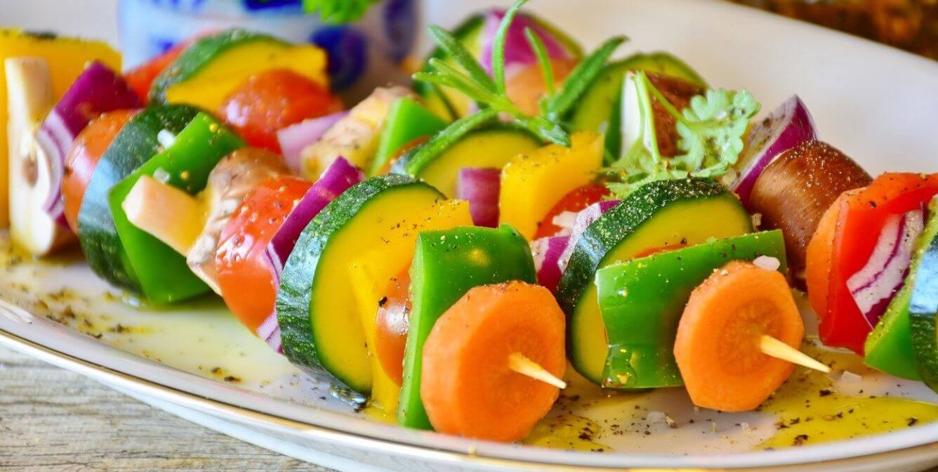 Colorful vegetable skewers with carrots, peppers, tomatoes, etc.