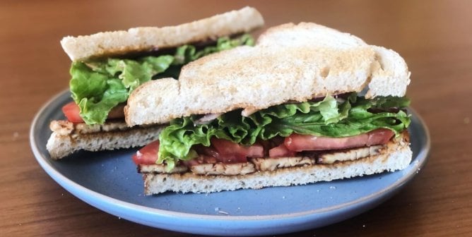 tempeh blt sandwich on a blue plate