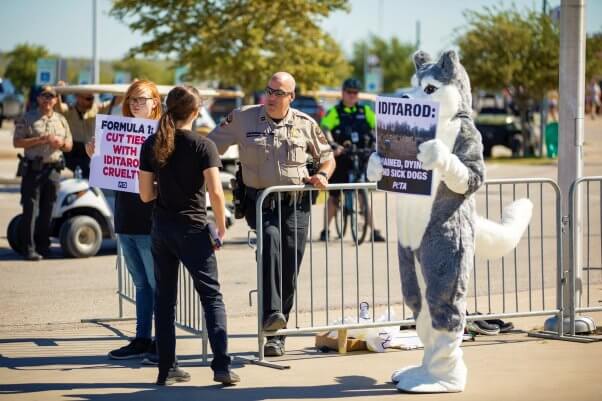 police officer talks to protesters at Iditarod demo