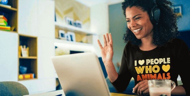 Person with PETA shirt working on computer