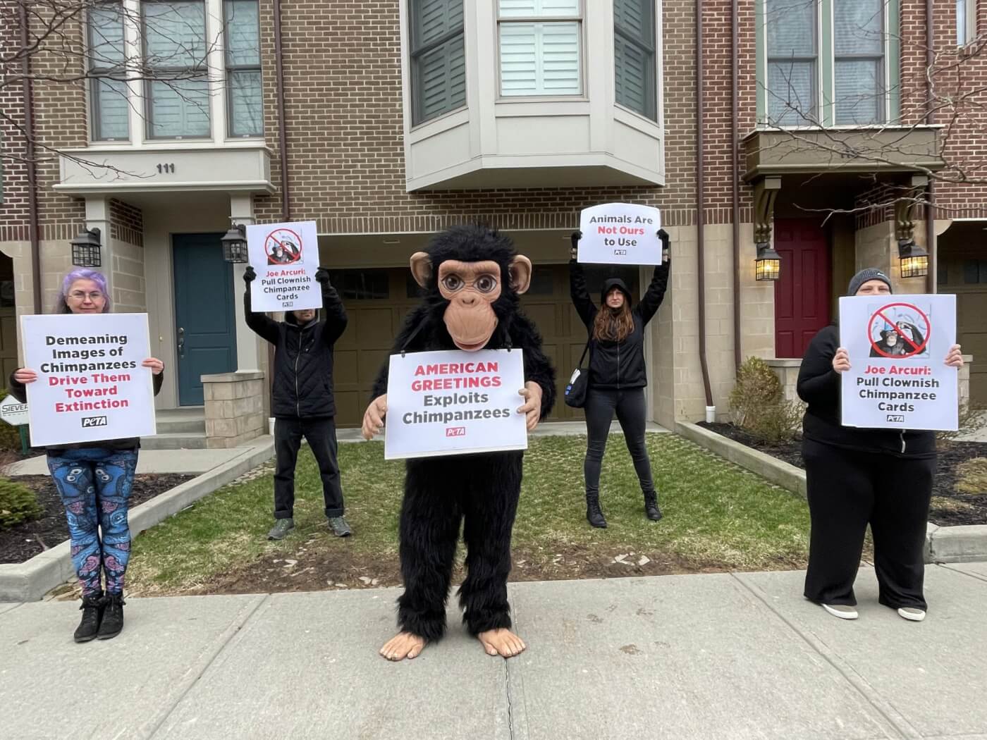 protestors dressed as chimpanzees speaking up for animals used for entertainment outside American Greetings CEO's house