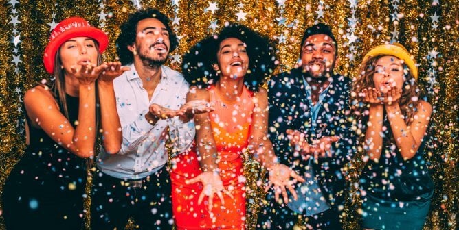 new year party of five people celebrating with confetti