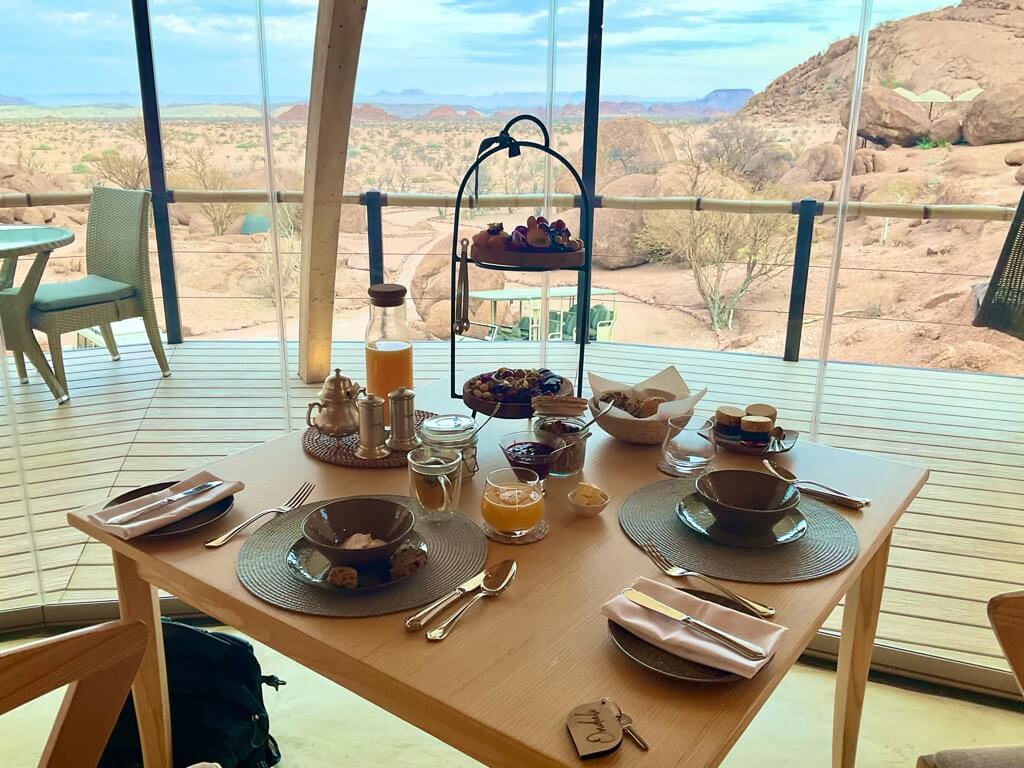 vegan meal on a table with beautiful African safari landscape in the background