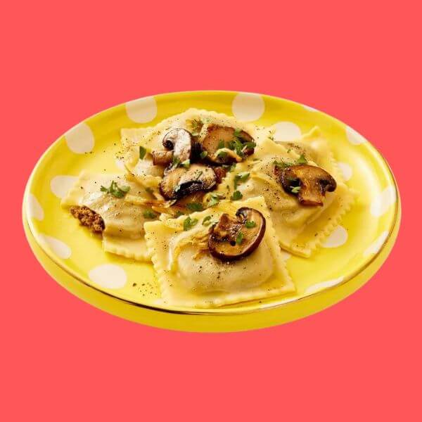 a plate with Tabitha Brown for Target polenta and mushroom vegan ravioli