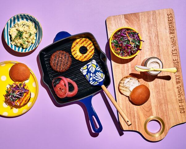 cast iron grill pan and cutting board with vegan food