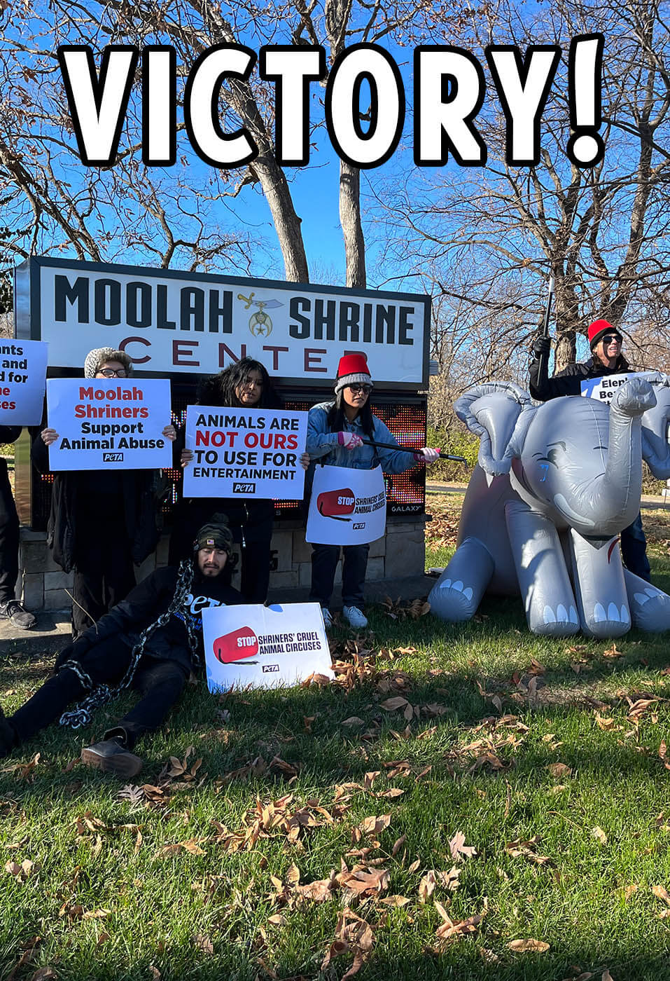 Protest in front of Moolah Shrine sign with victory text