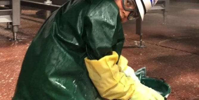 worker cleaning at a JBS slaughterhouse