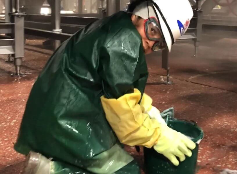 worker cleaning at a JBS slaughterhouse