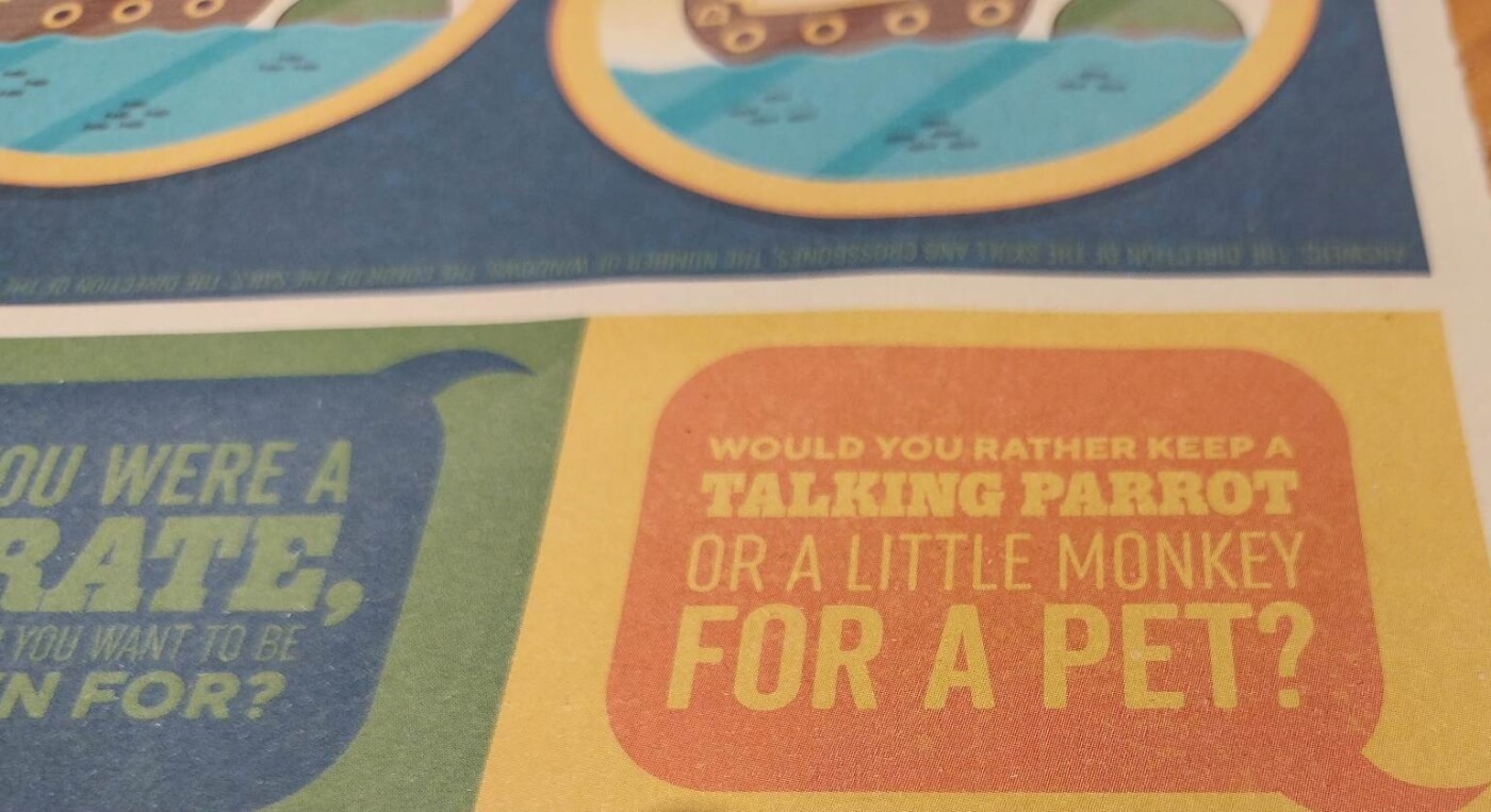 close-up of a section of Chili's restaurant chain's children's placemat with the question, "Would you rather have a talking parrot or a little monkey for a pet?" but is no longer in use