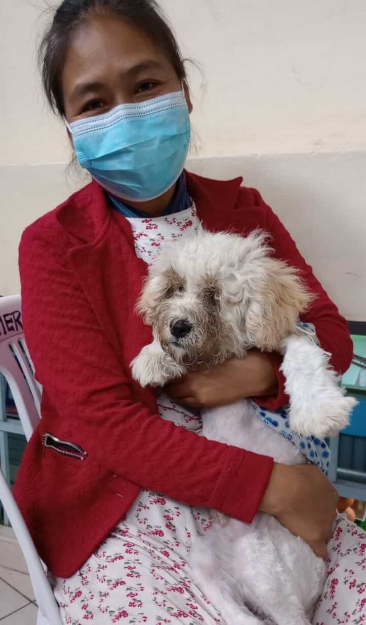 A woman holds her dog at PETA's Spay-a-Thon in Peru