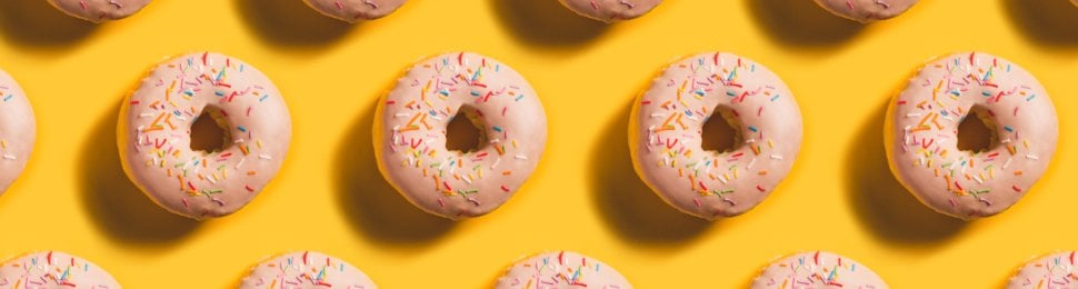 pattern of pink donuts on a yellow background