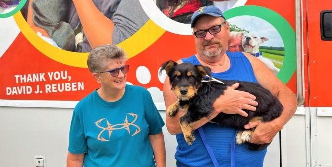 two guardians with dog at Galax spay clinic