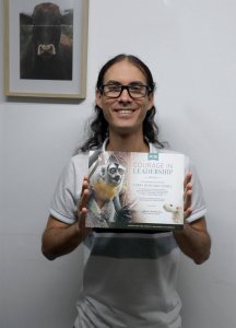 Photo of Hurtado holding certificate