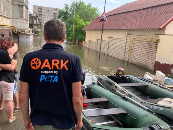 ARK rescue team member in front of boat