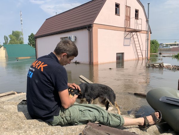 ARK rescuer with dog by flood waters