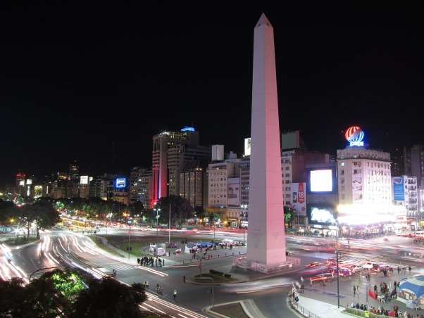 night time scene of buenos aires' obelisk in the middle of a bustling intersection