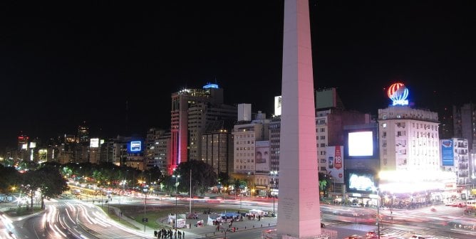 night time scene of buenos aires' obelisk in the middle of a bustling intersection